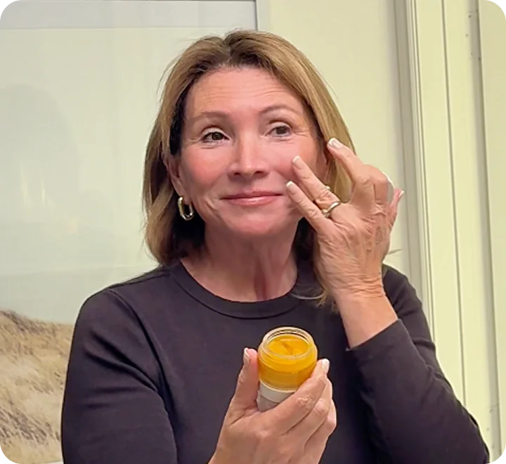 Woman applying Frøya Organics Nordic Skin and Hair Renewal System